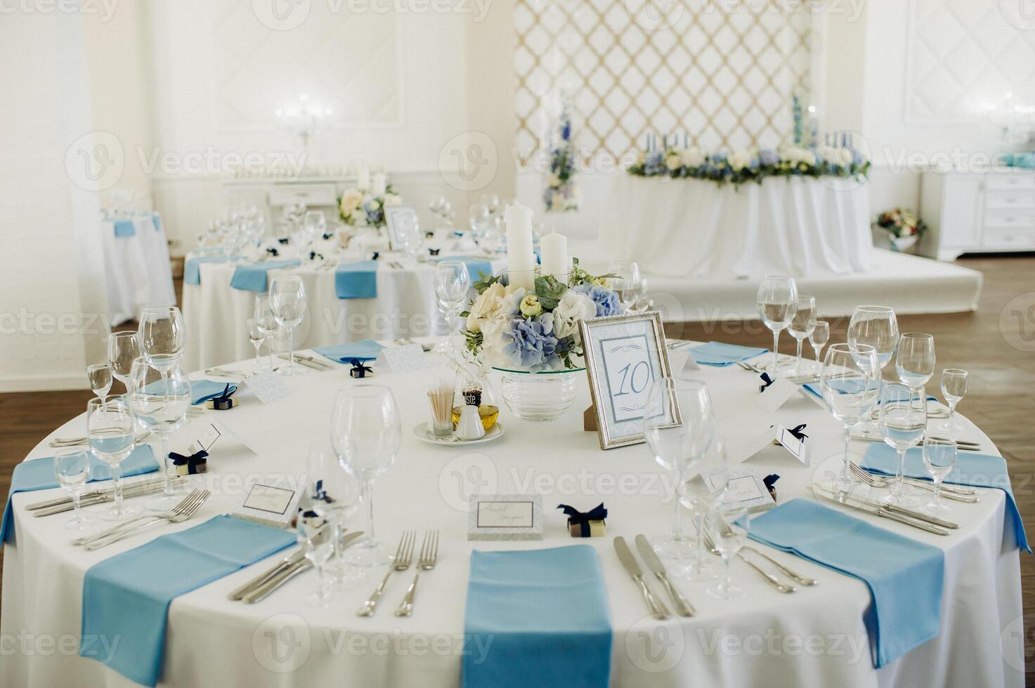 wedding table decoration with blue flowers on the table in the restaurant table decor for dinner at the wedding. photo