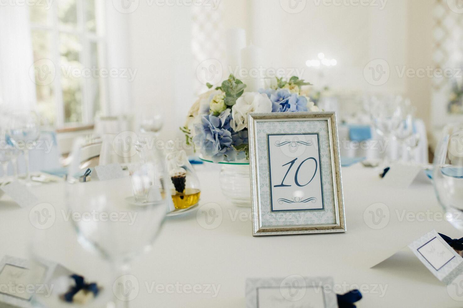 wedding table decoration with blue flowers on the table in the restaurant table decor for dinner at the wedding. photo