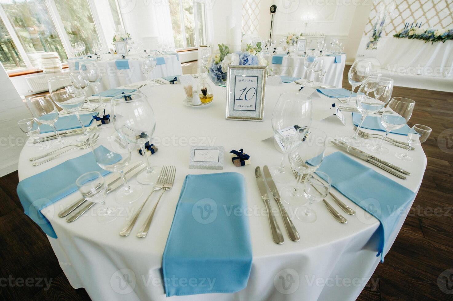 wedding table decoration with blue flowers on the table in the restaurant table decor for dinner at the wedding. photo