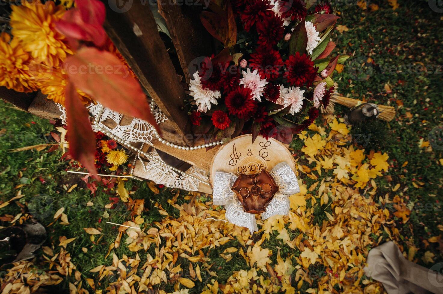 Autumn wedding ceremony on the street on the green lawn.Decor with arches of fresh flowers for the ceremony photo