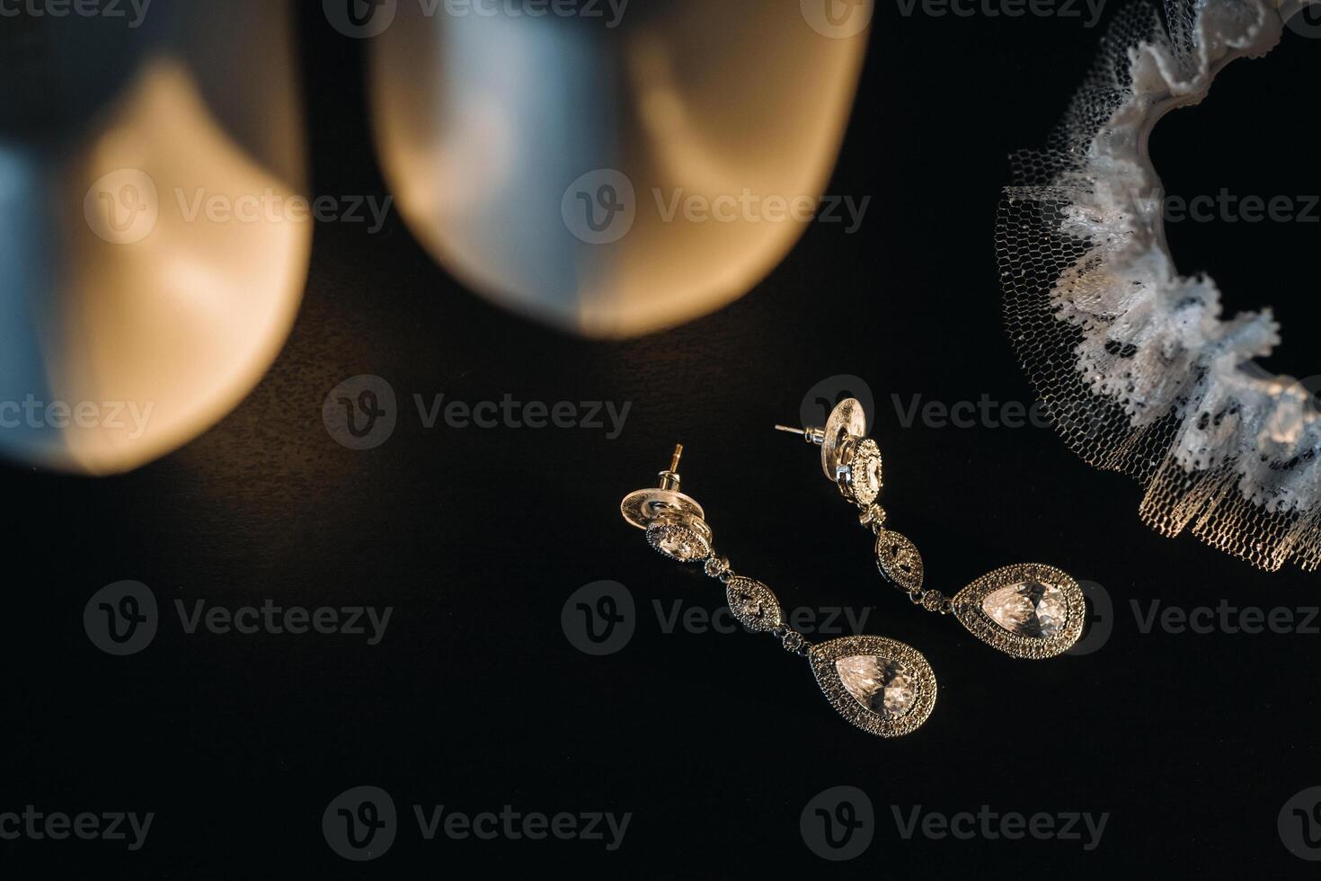 Accessories for the bride. Wedding Earrings on a black background. photo