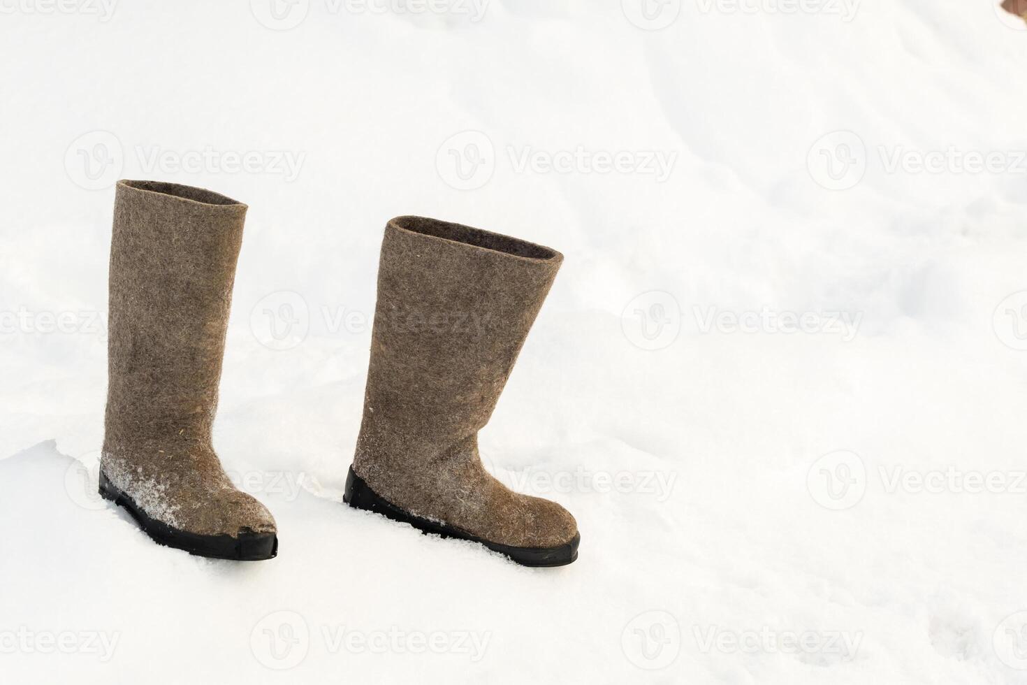 close up of felt boots standing in the snow photo