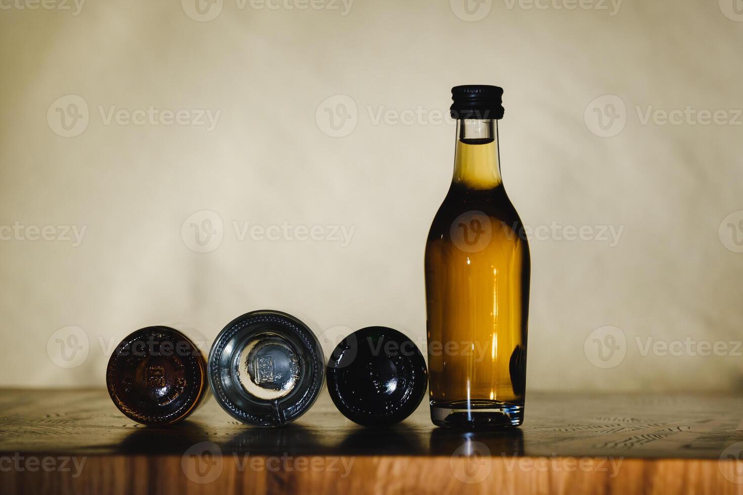 different alcohol bottles are on the table on a light background photo