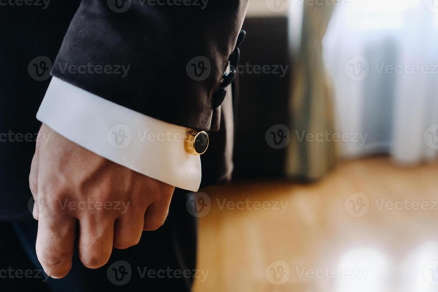 Close-up of a man's hands in a black formal suit with cuffs photo