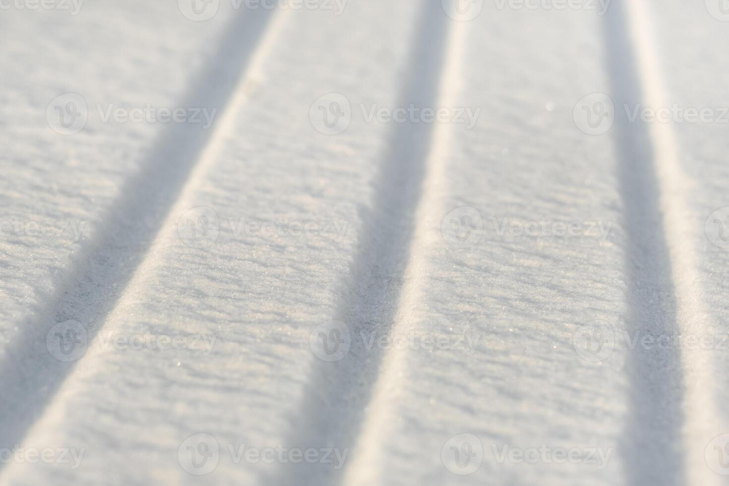 winter background. The texture of snow with stripes. Pure white snow photo