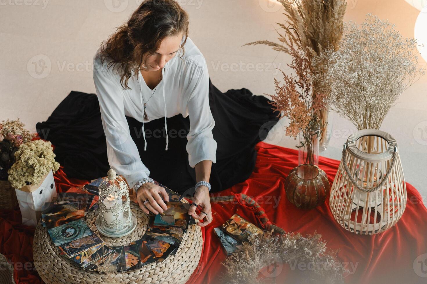 Women's circle and practice in the use of metaphorical cards. The girl is sitting surrounded by flowers photo
