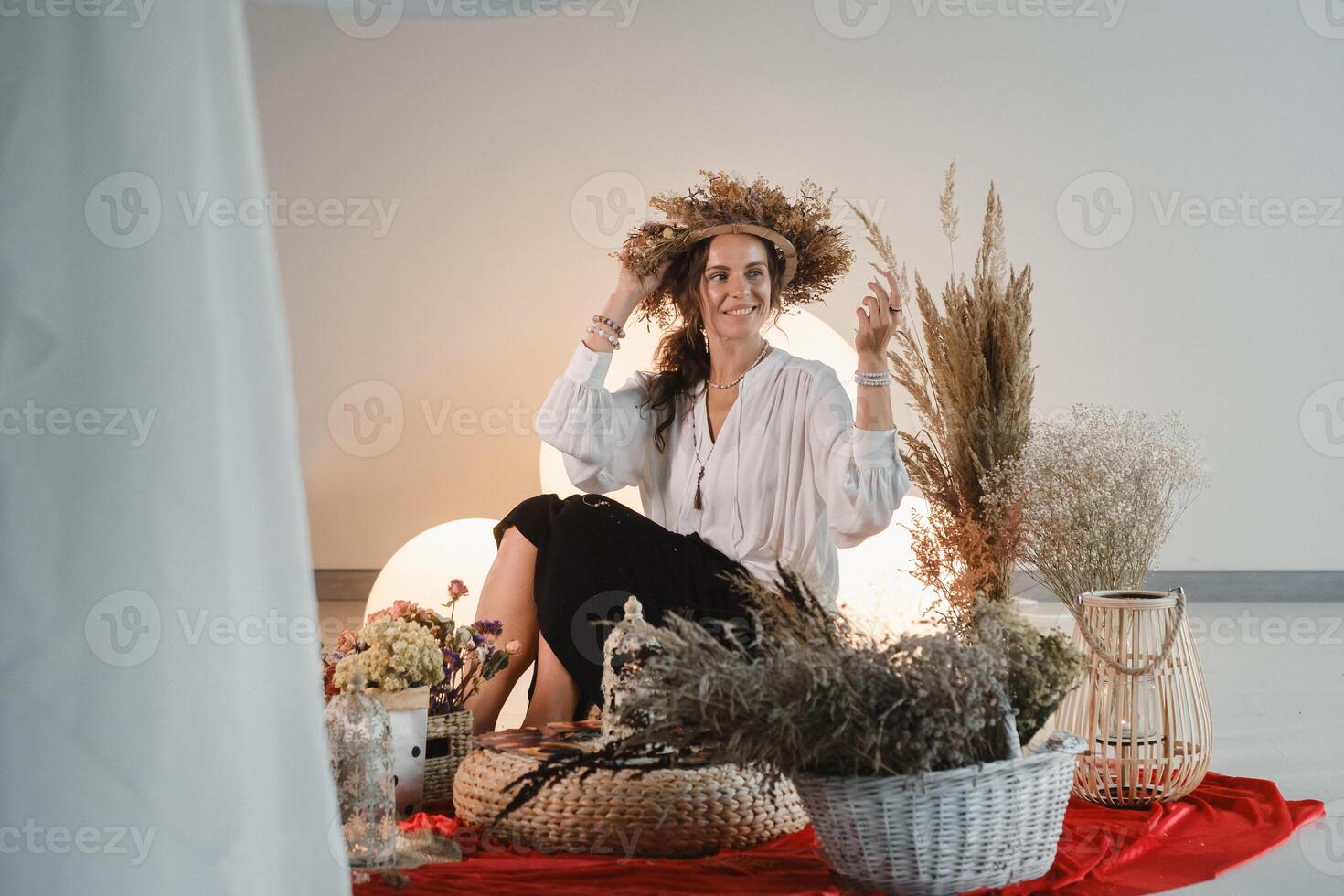 Women's circle and practice in the use of metaphorical cards. The girl is sitting surrounded by flowers photo