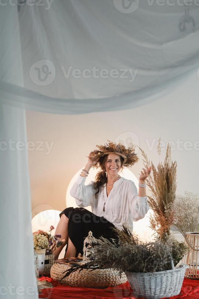 Women's circle and practice in the use of metaphorical cards. The girl is sitting surrounded by flowers photo