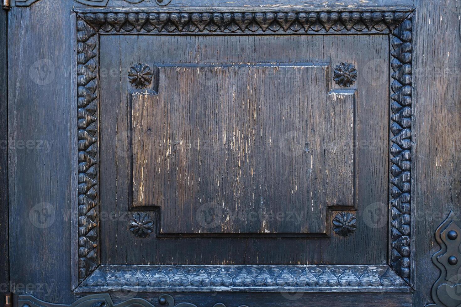 part of an old wooden door with a stained glass pattern photo