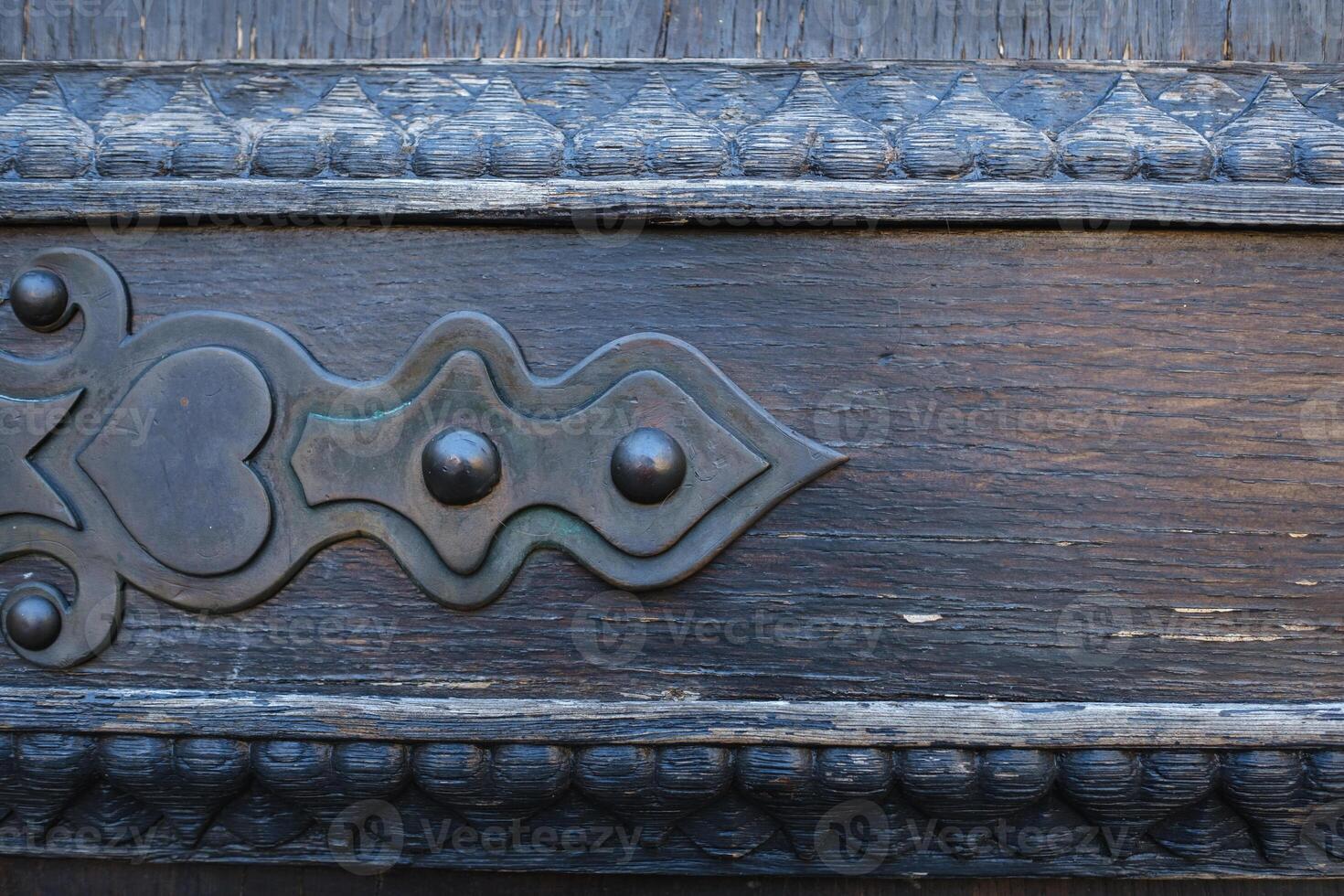 part of an old wooden door with a stained glass pattern photo