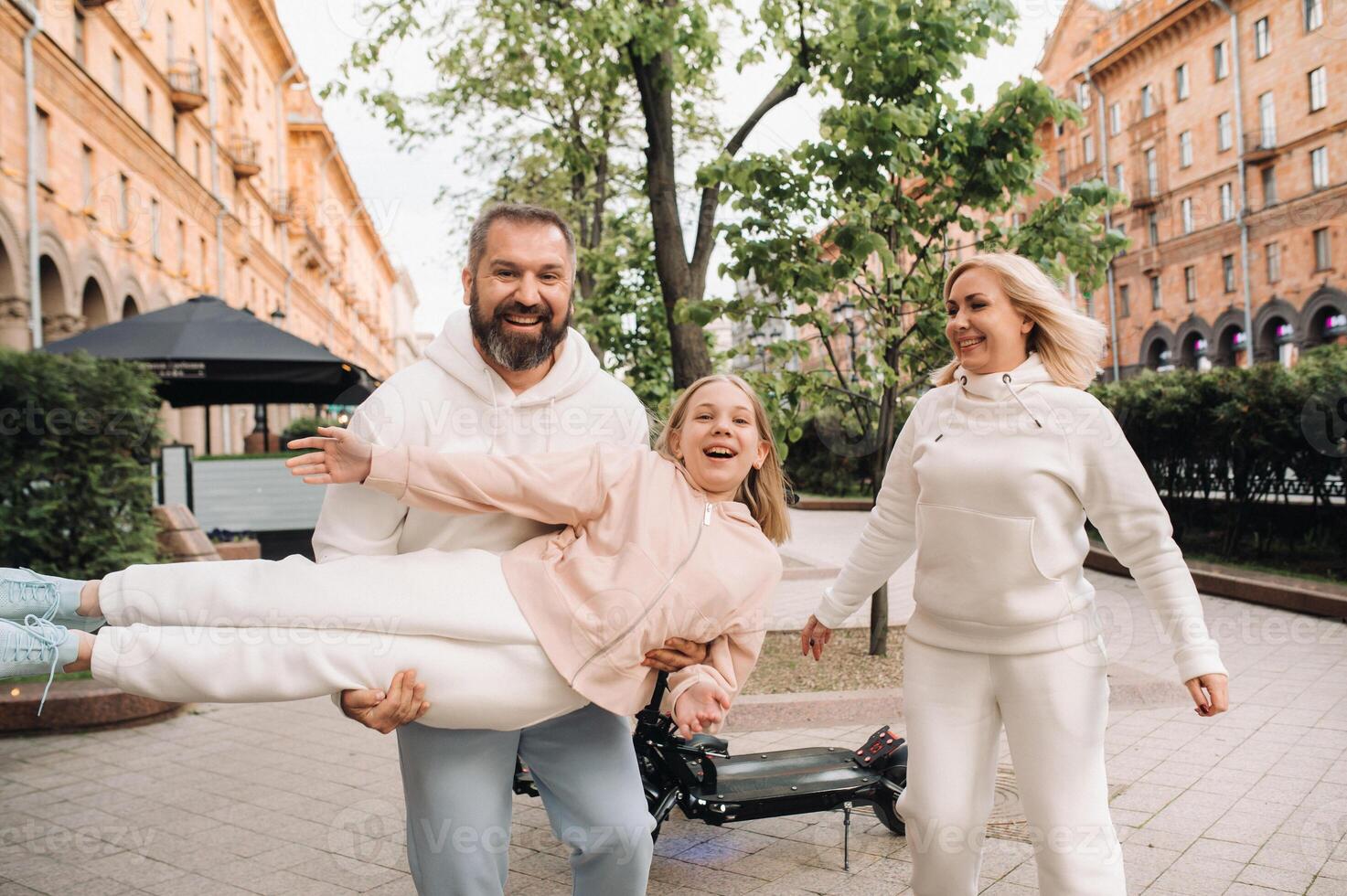 A happy family in white clothes walks around the city.A fun walk photo