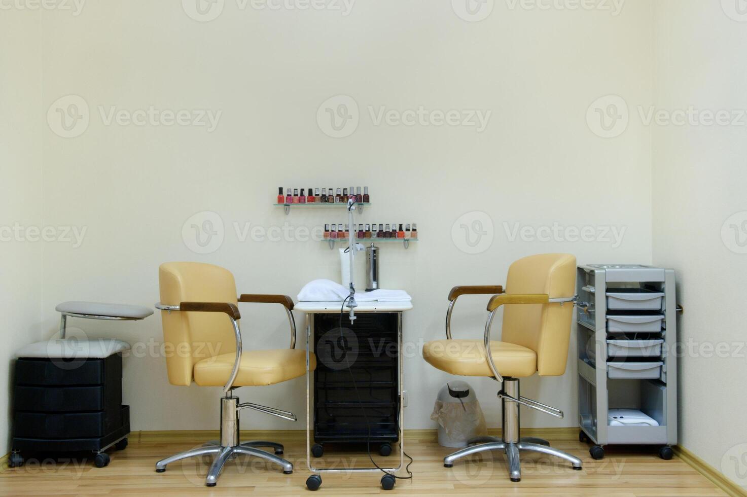 place for a manicure in a beauty salon in bright colors.Two chairs and a table in the nail care room photo