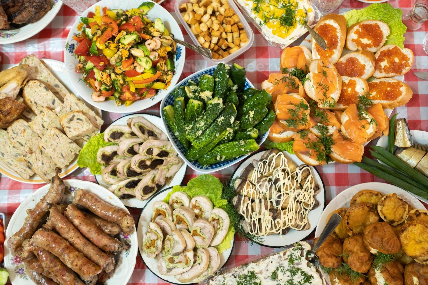 A lot of different food on the Banquet table.A large number of prepared dishes on the table.Holiday at the table photo