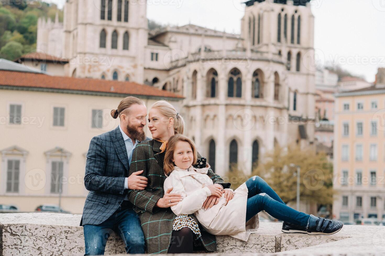 A beautiful family with strolls through the old city of Lyon in France.Family trip to the old cities of France photo