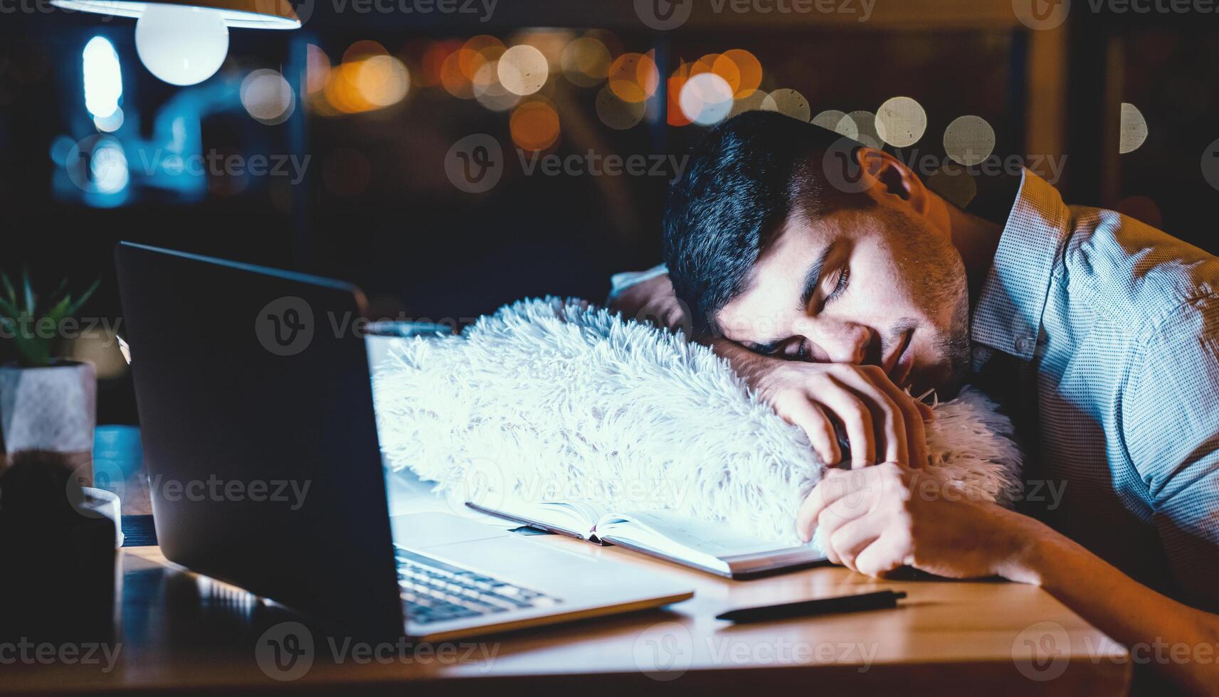 Night Shift. Tired Man Sleeping Working On Laptop Overnight Sitting At Workdesk In Modern Office. Selective Focus photo