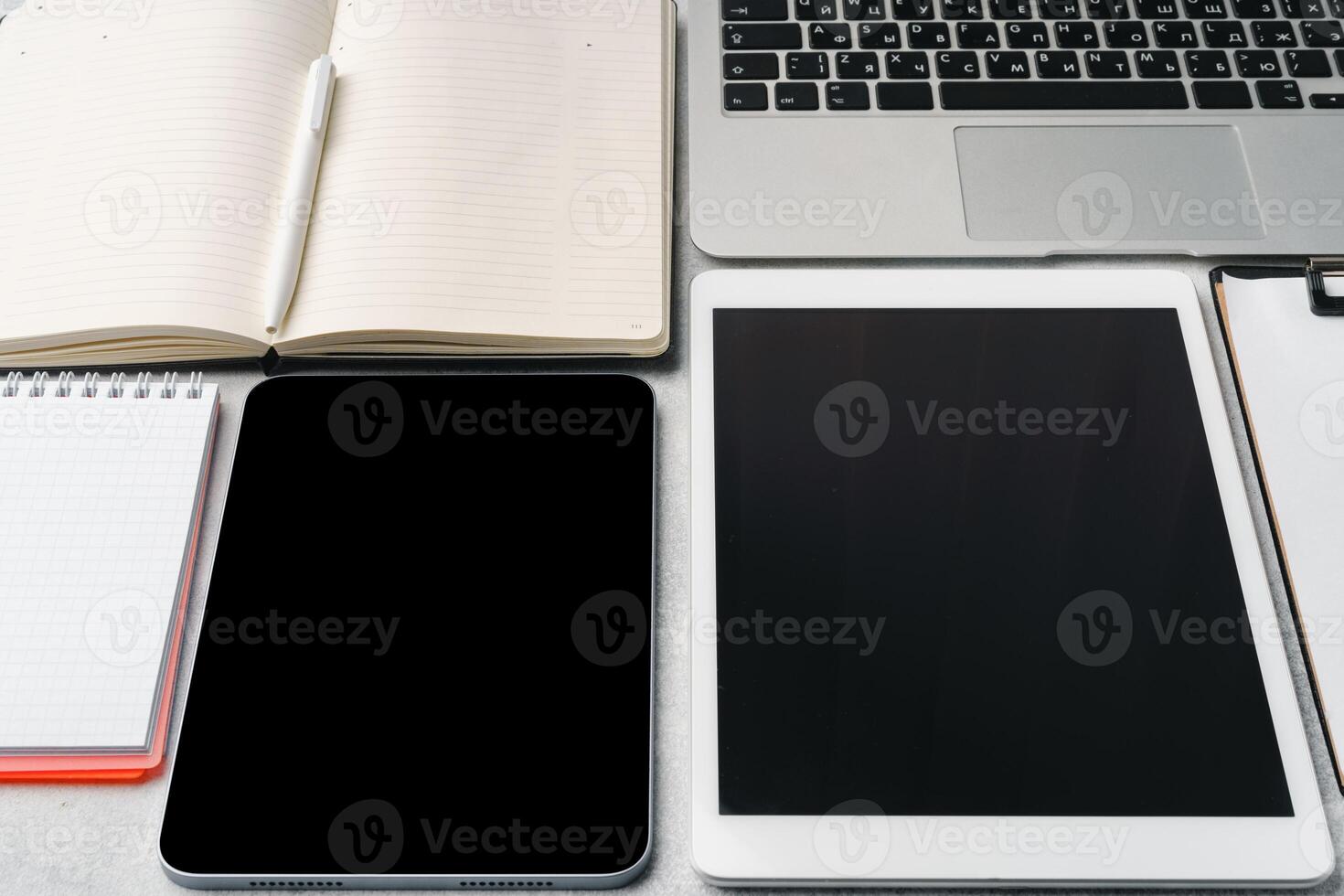 Office supplies and digital tablet on office table photo