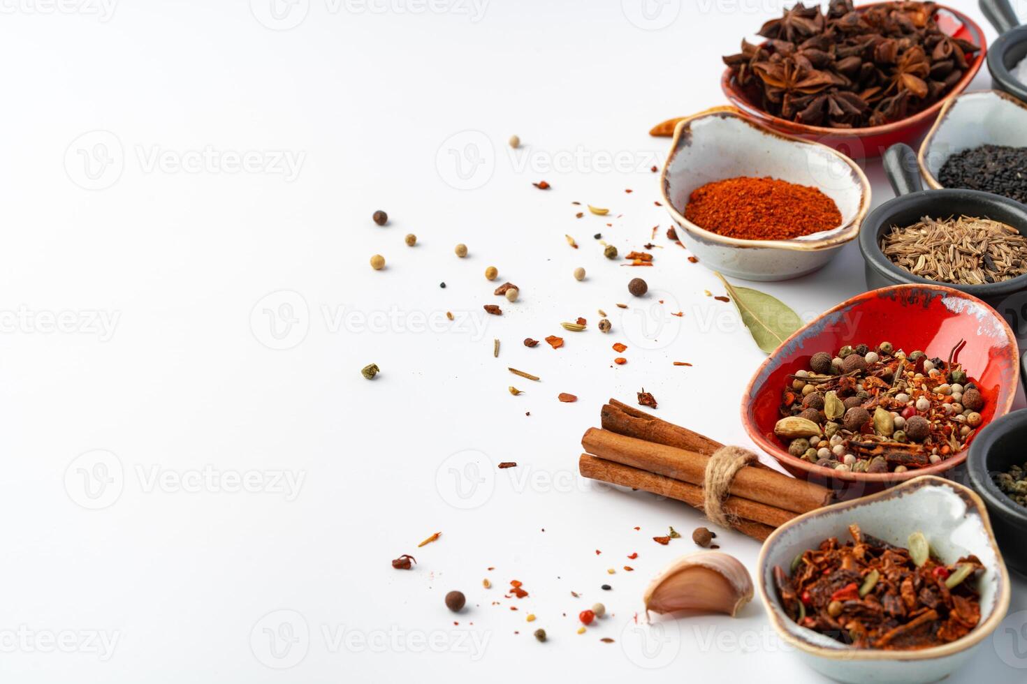 Bowls with various spices on white background photo