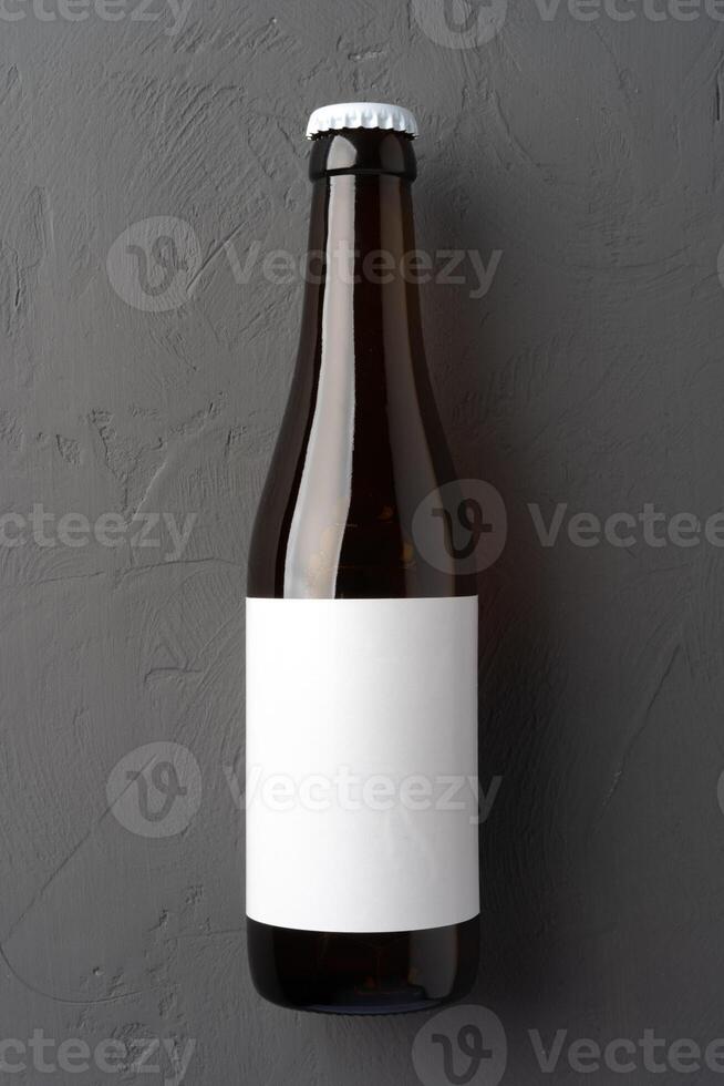 Beer bottle, on gray stone background, top view, with copy space for text photo