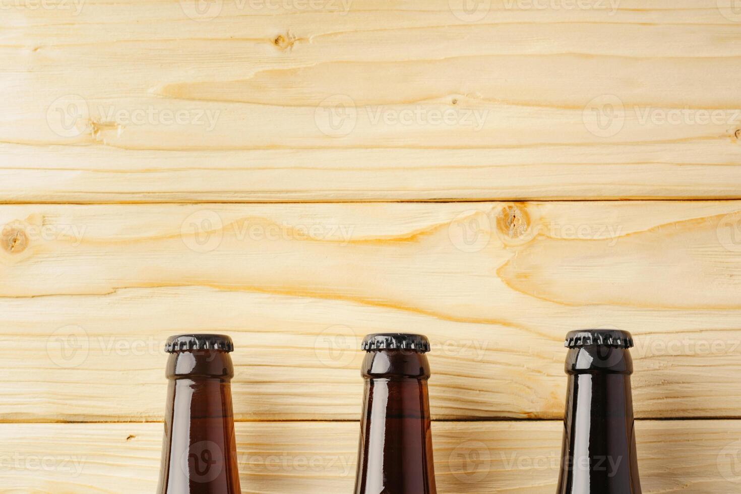 Beer bottle on a brown wooden table flat lay background with a copy space photo