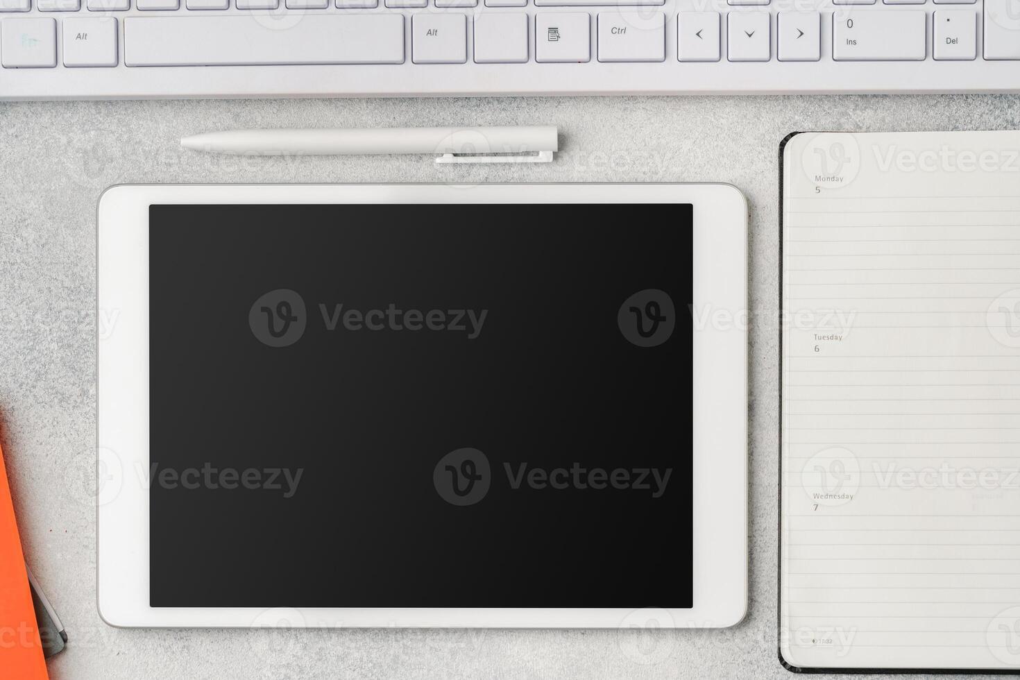 Digital tablet with empty screen on table with business accessories photo