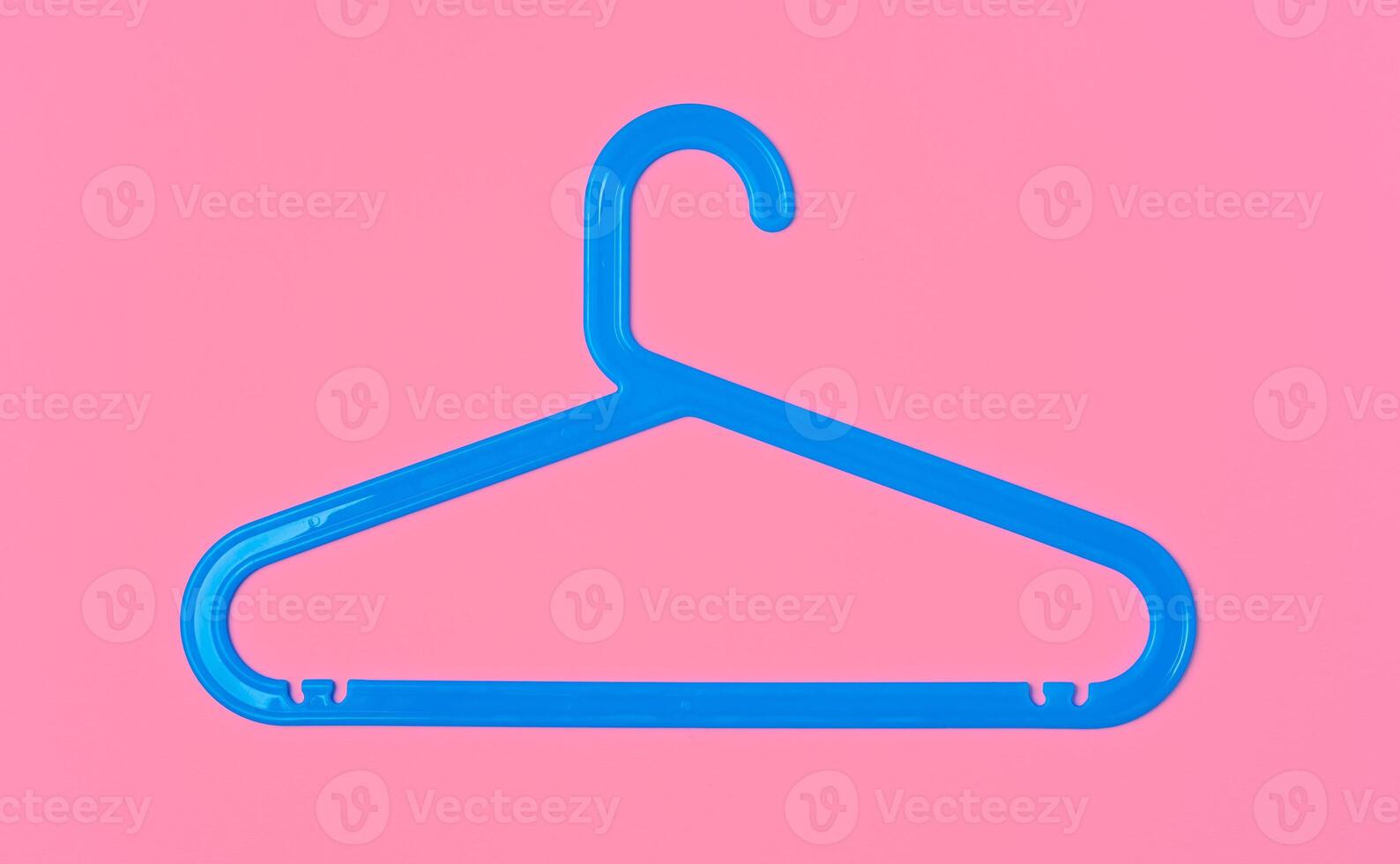 Flat lay composition with empty hangers on pink background photo