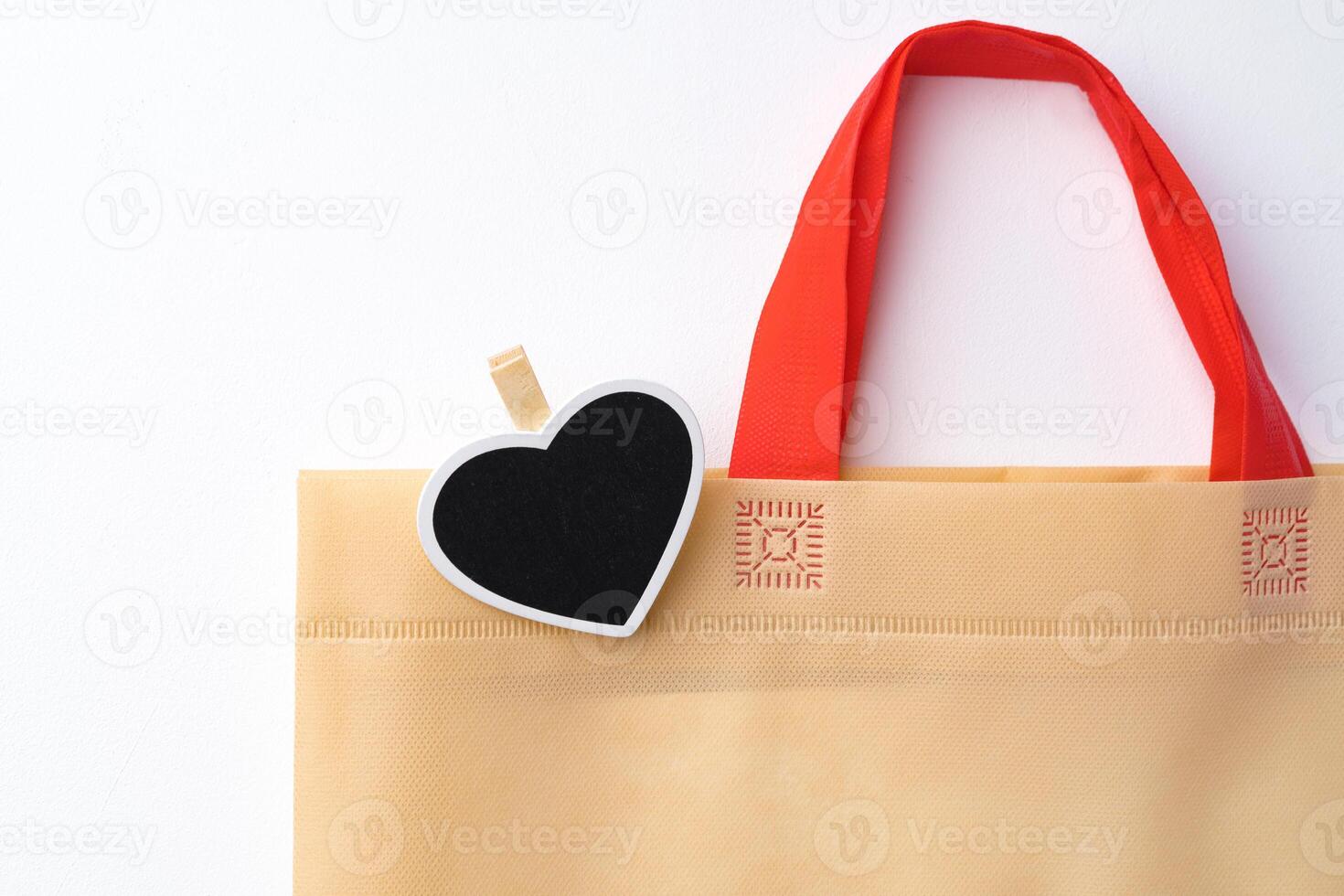 Cotton tote shopper bag with heart tag on white background photo