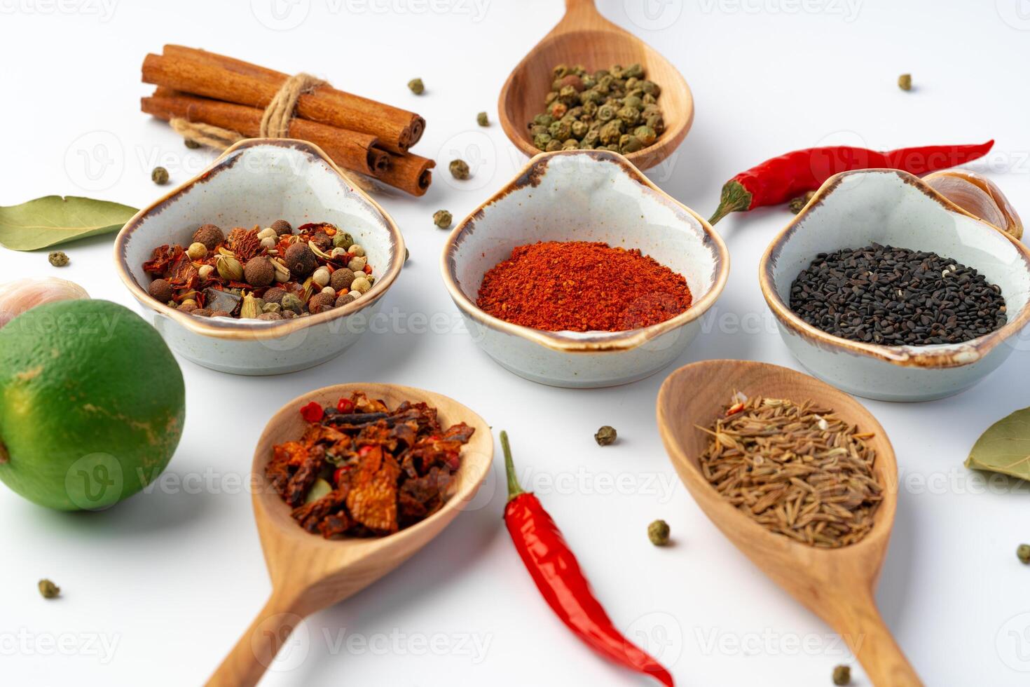 Bowls with various spices on white background photo