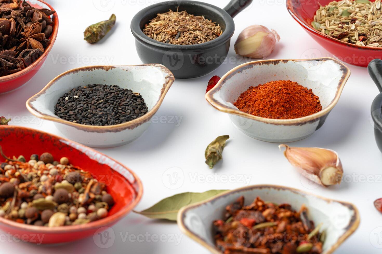 Bowls with various spices on white background photo
