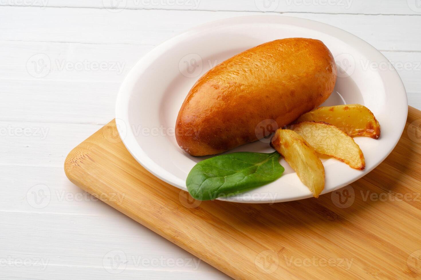 Traditional Russian pie or patty on white plate photo