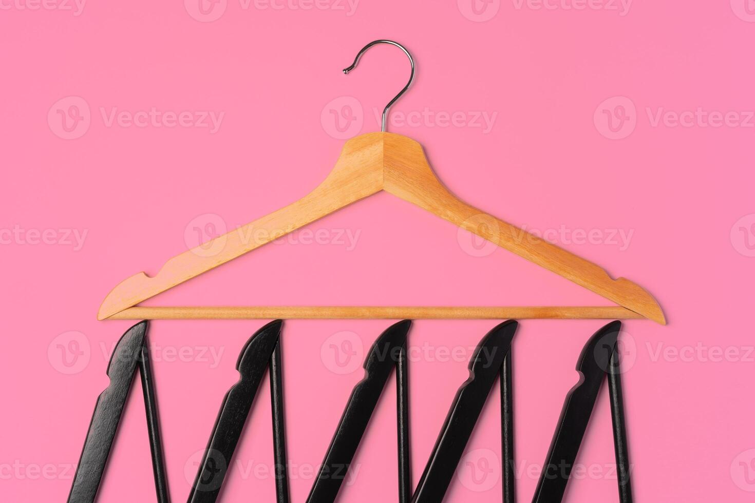 Flat lay composition with empty hangers on pink background photo