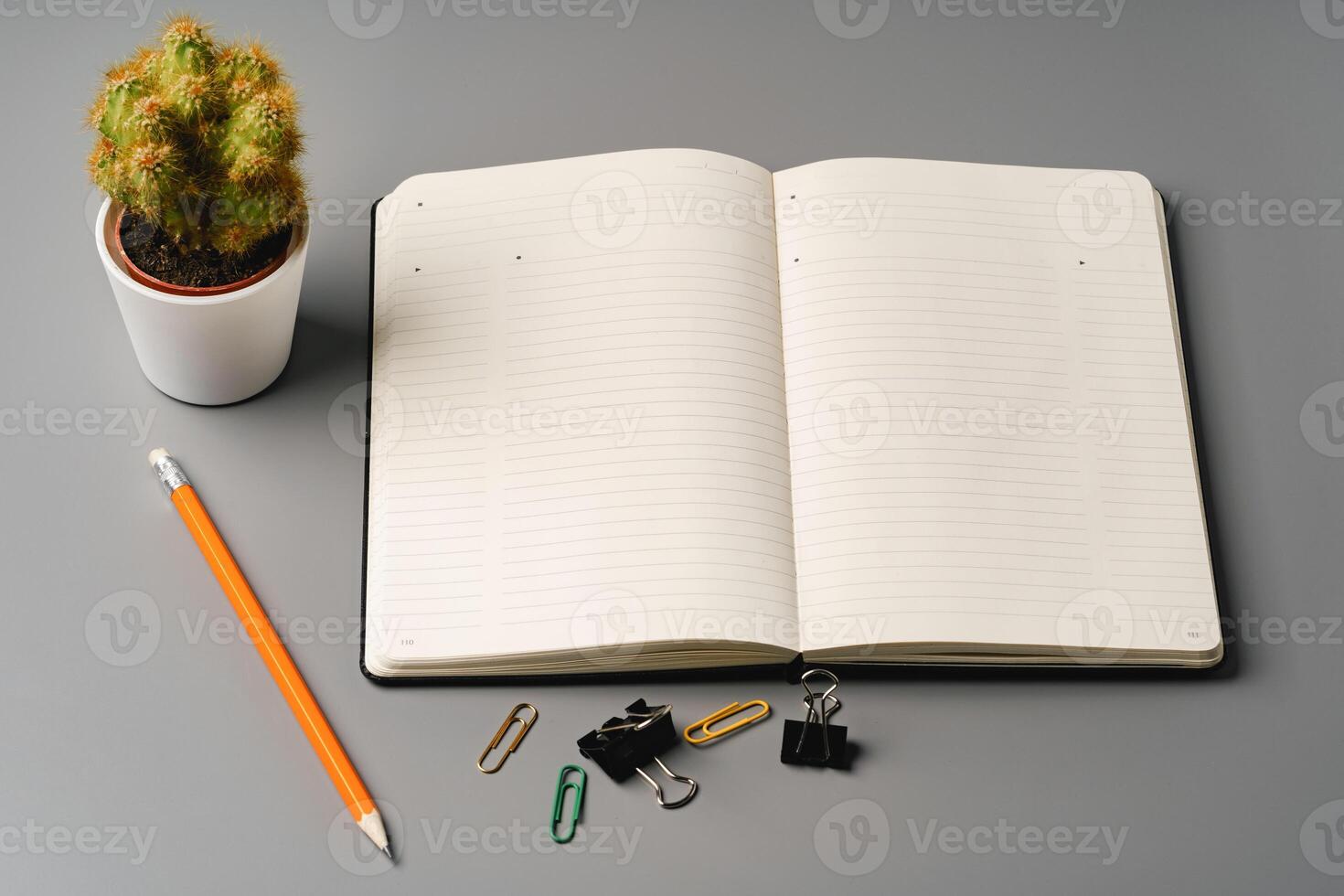Blank notebook with pen are on top of office desk table photo