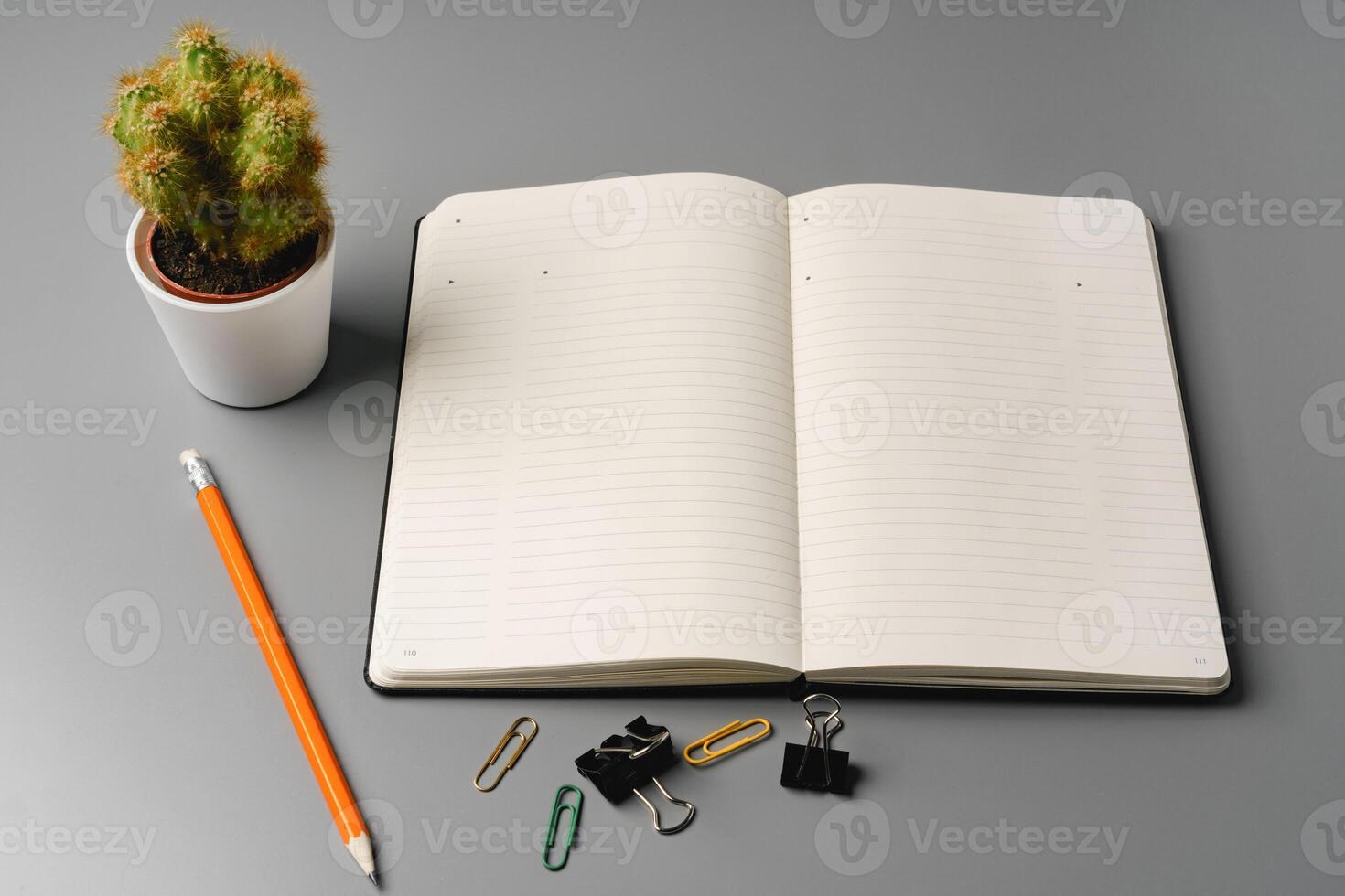 Blank notebook with pen are on top of office desk table photo