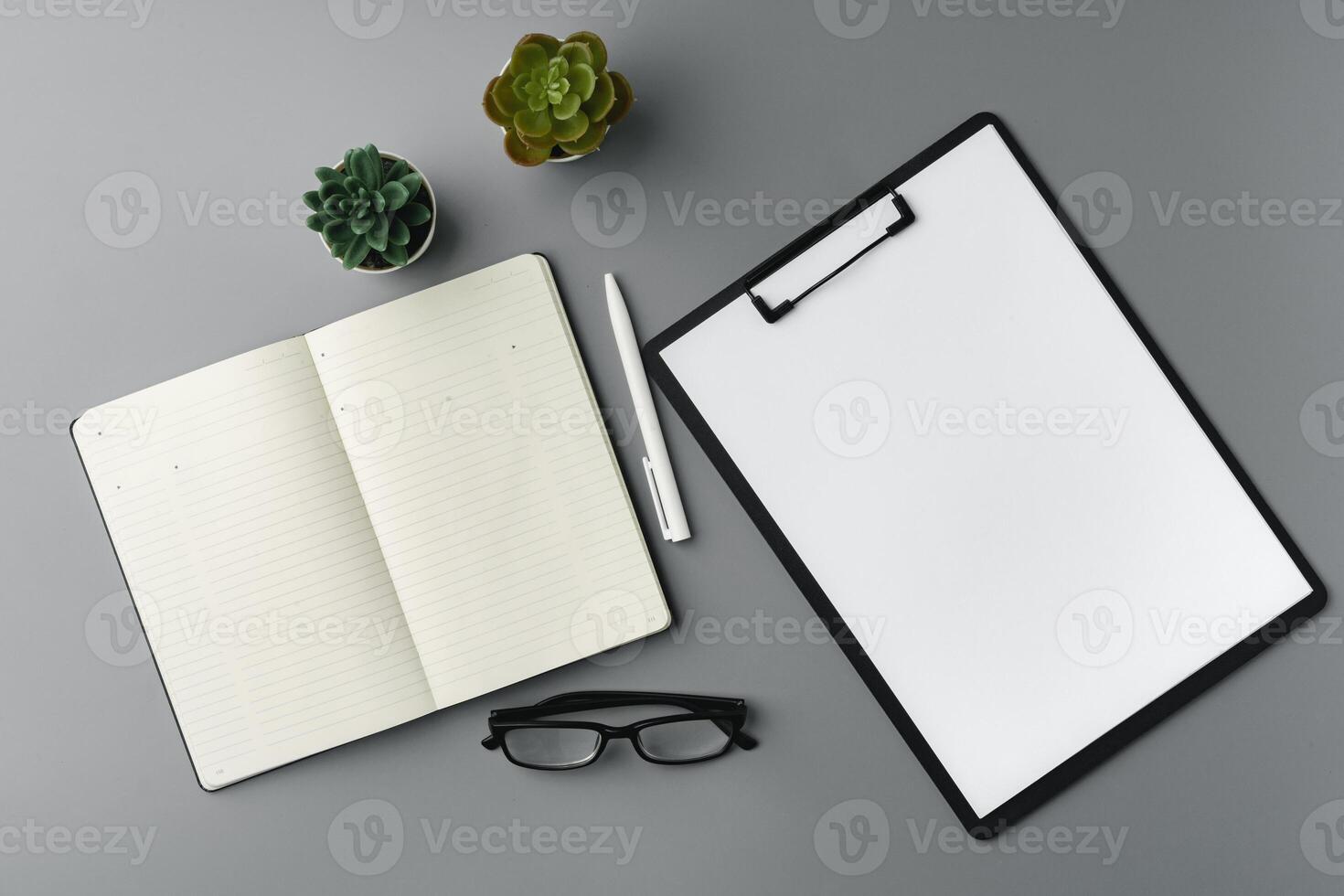 Blank notebook with pen are on top of office desk table photo