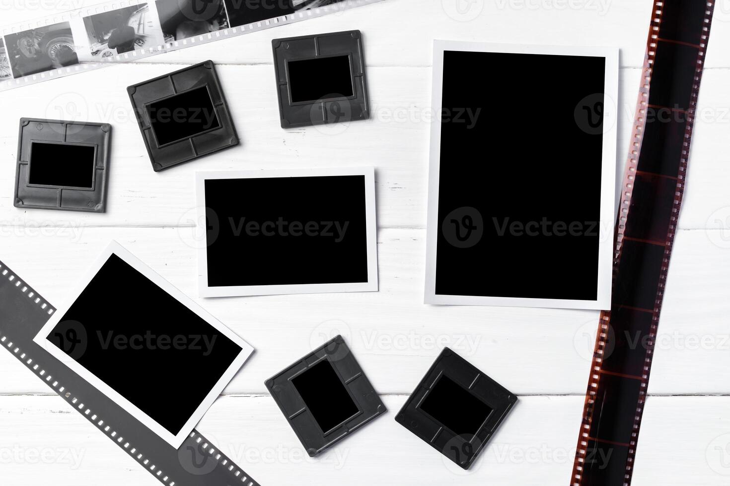 Old vintage film, slides and photos on white wooden background