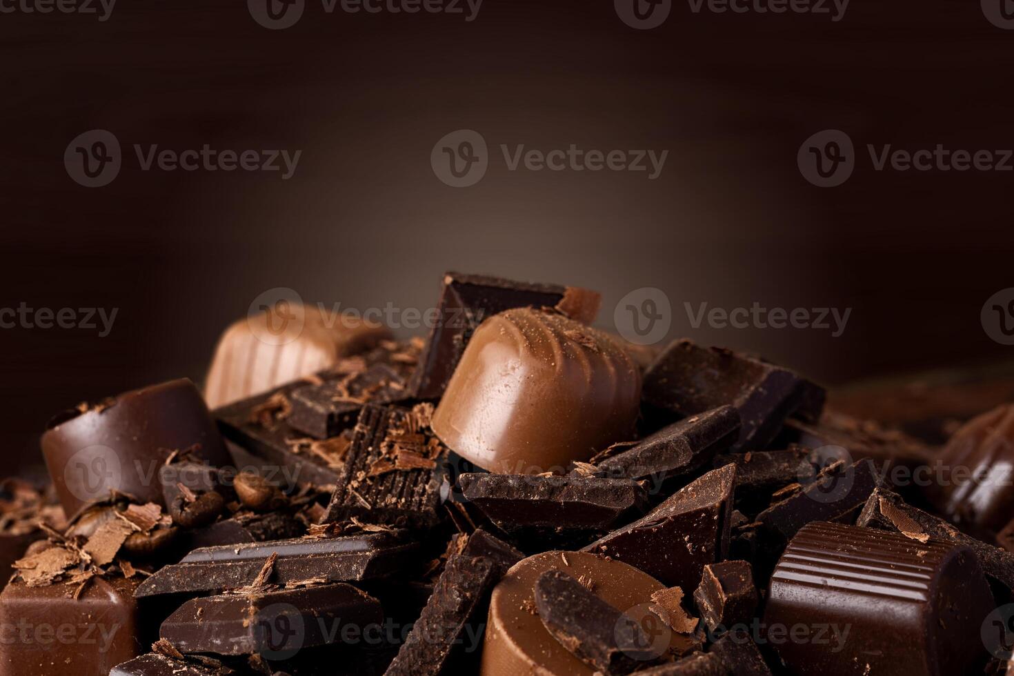Chocolate candies and chocolate pieces pile for background photo