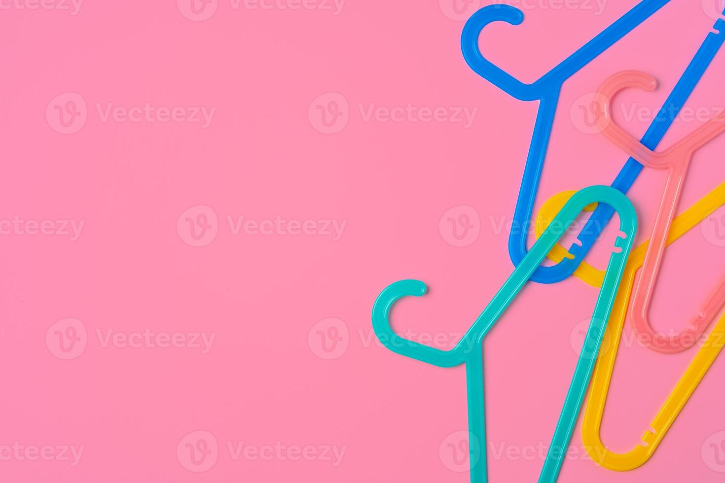 Flat lay composition with empty hangers on pink background photo