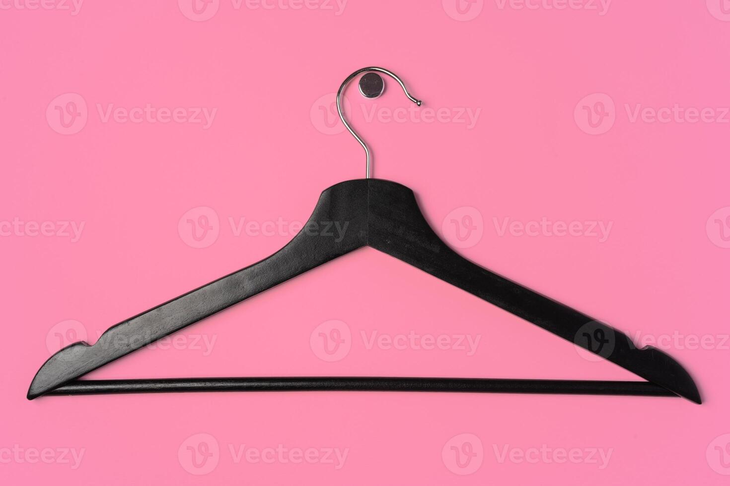 Flat lay composition with empty hangers on pink background photo