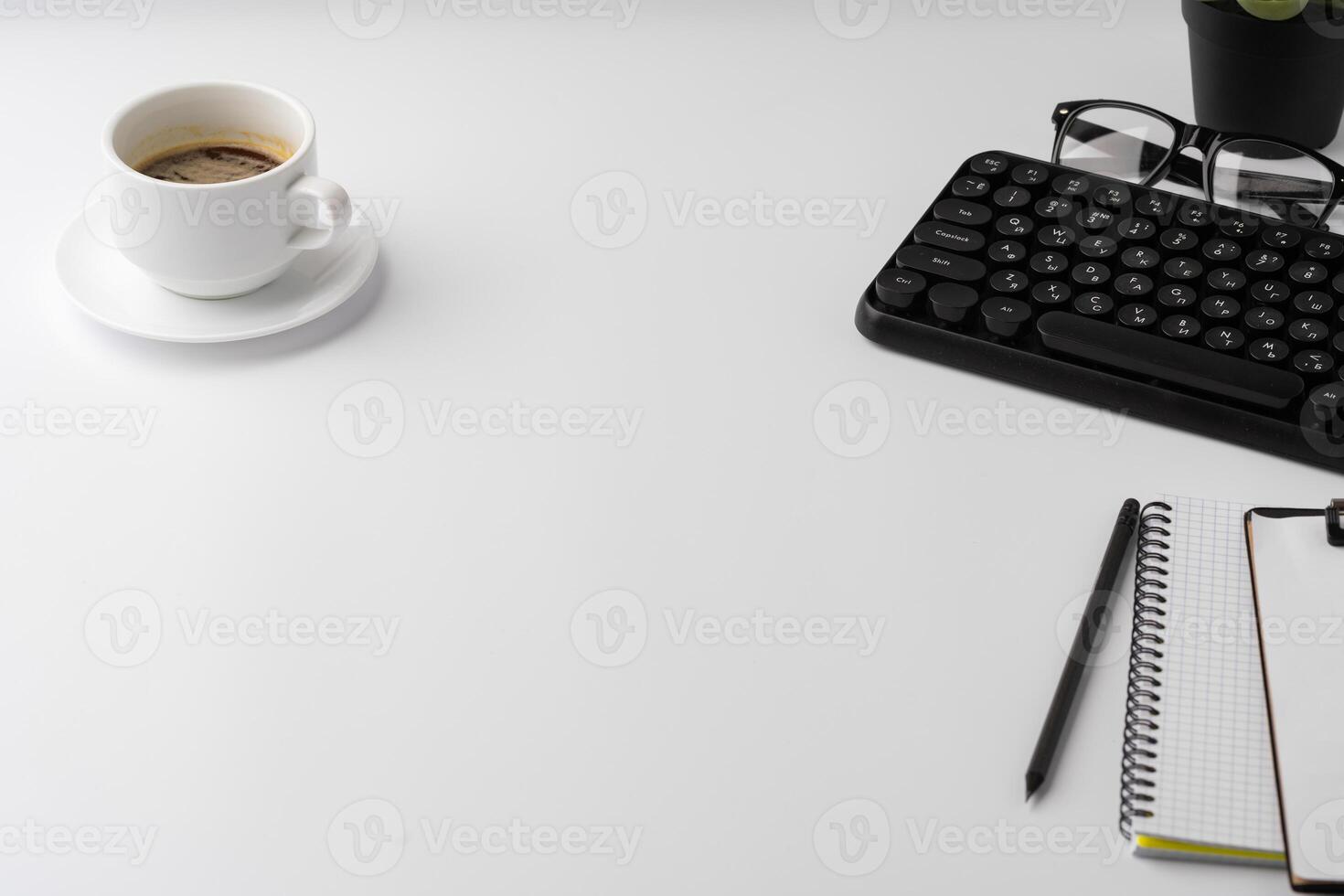 Office desk with laptop, blank notebook and coffee cup photo