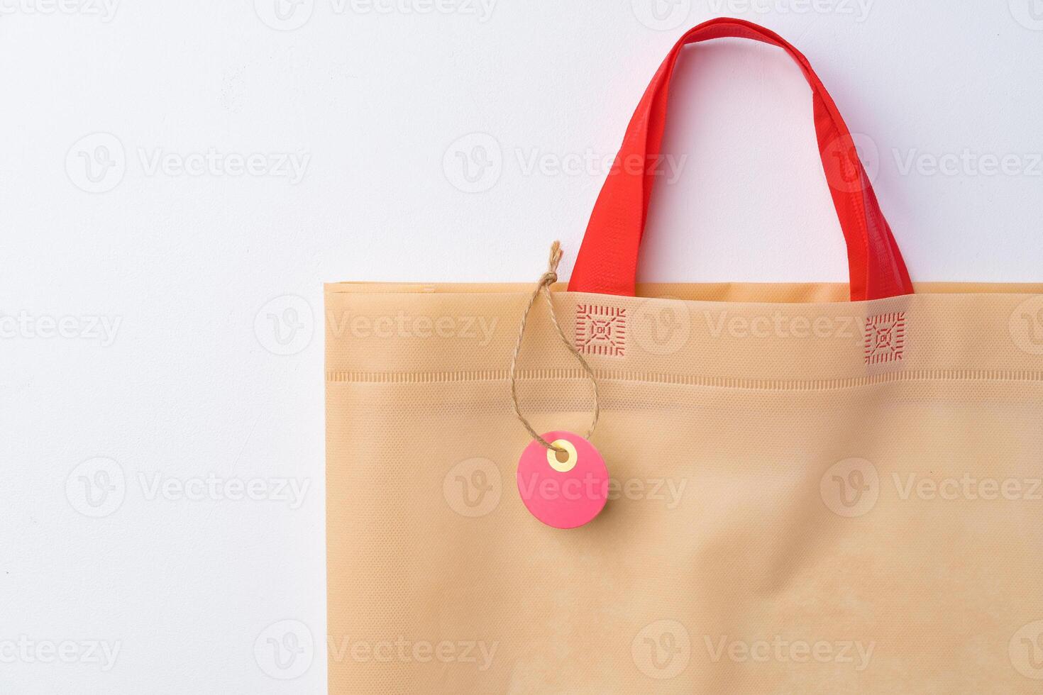 Blank paper tag with shopper paperbag on white background photo