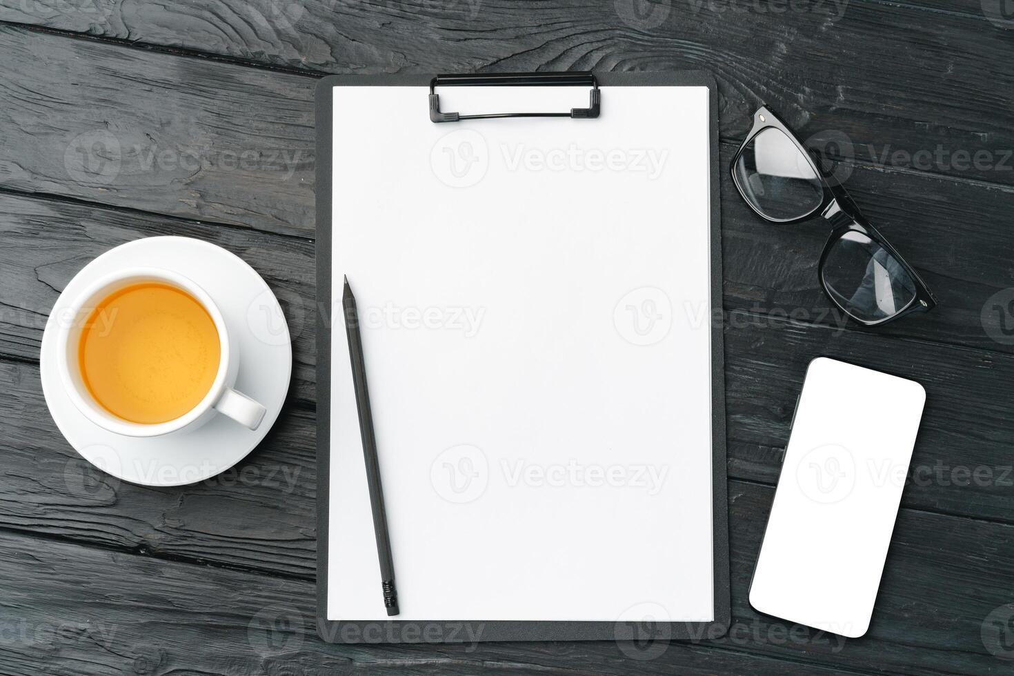 Blank paper on clipboard with space on dark gray background photo