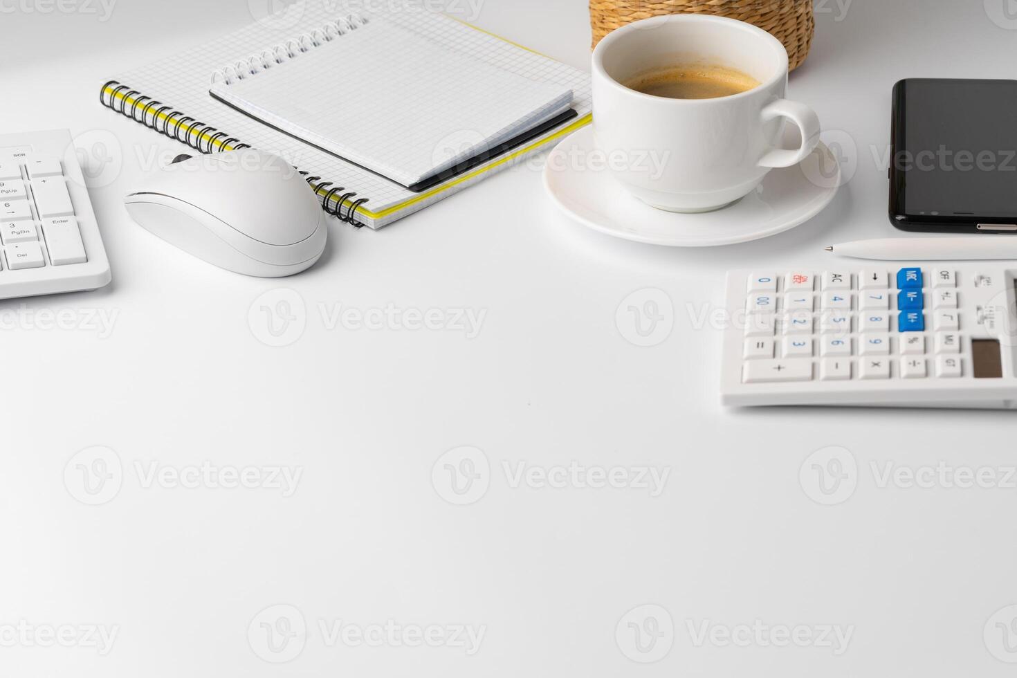 Office desk with laptop, blank notebook and coffee cup photo