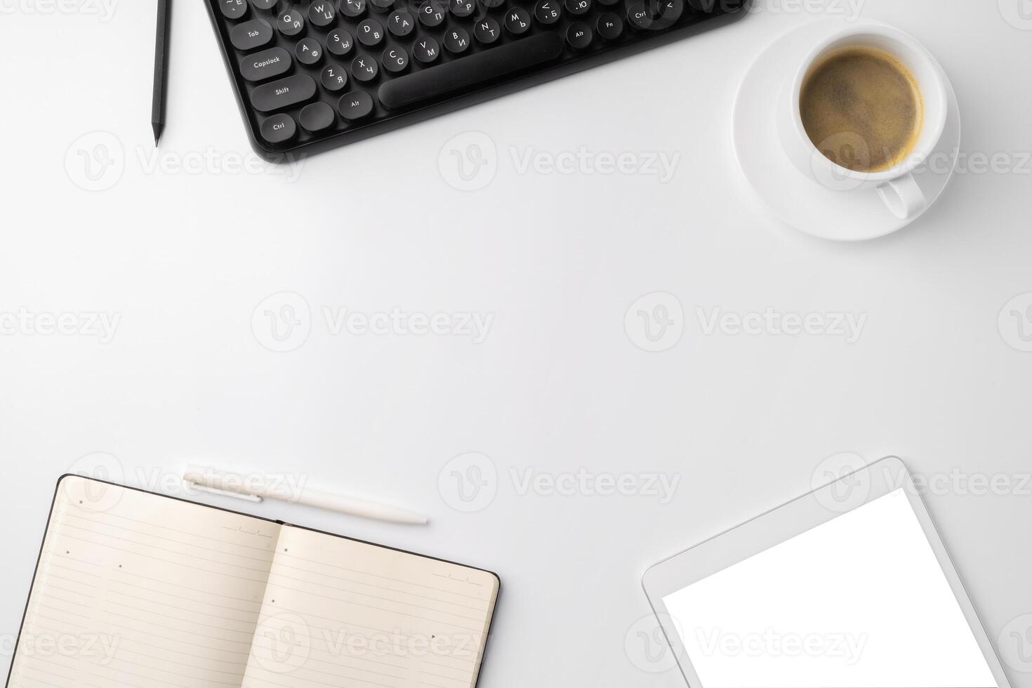 Office desk with laptop, blank notebook and coffee cup photo