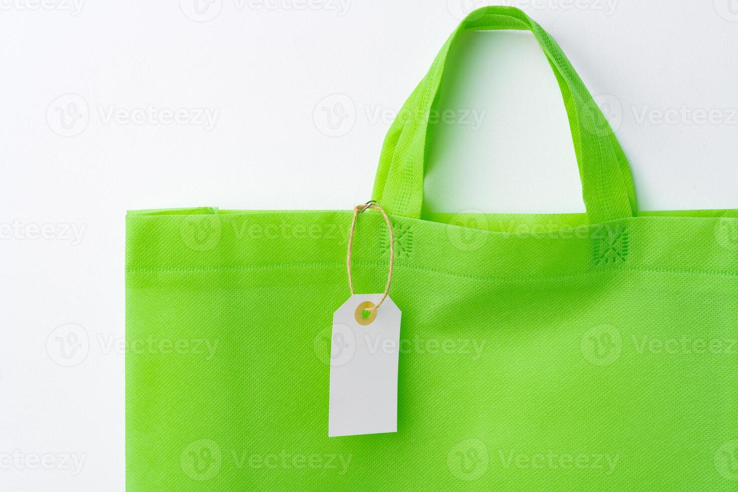 Blank paper tag with shopper paperbag on white background photo