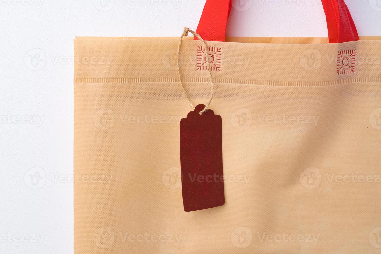 Blank paper tag with shopper paperbag on white background photo