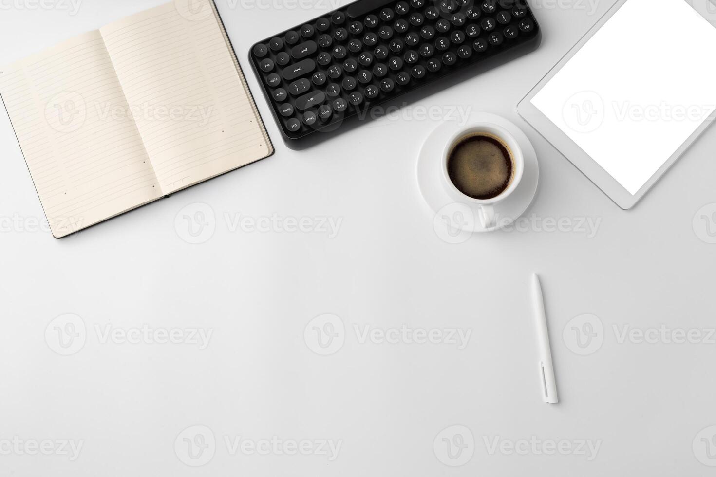 Minimalistic white workplace with keyboard and notebook photo