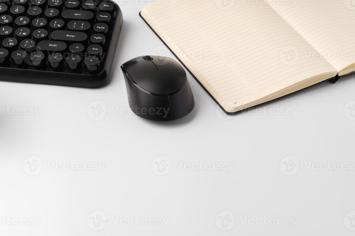Minimalistic white workplace with keyboard and notebook photo
