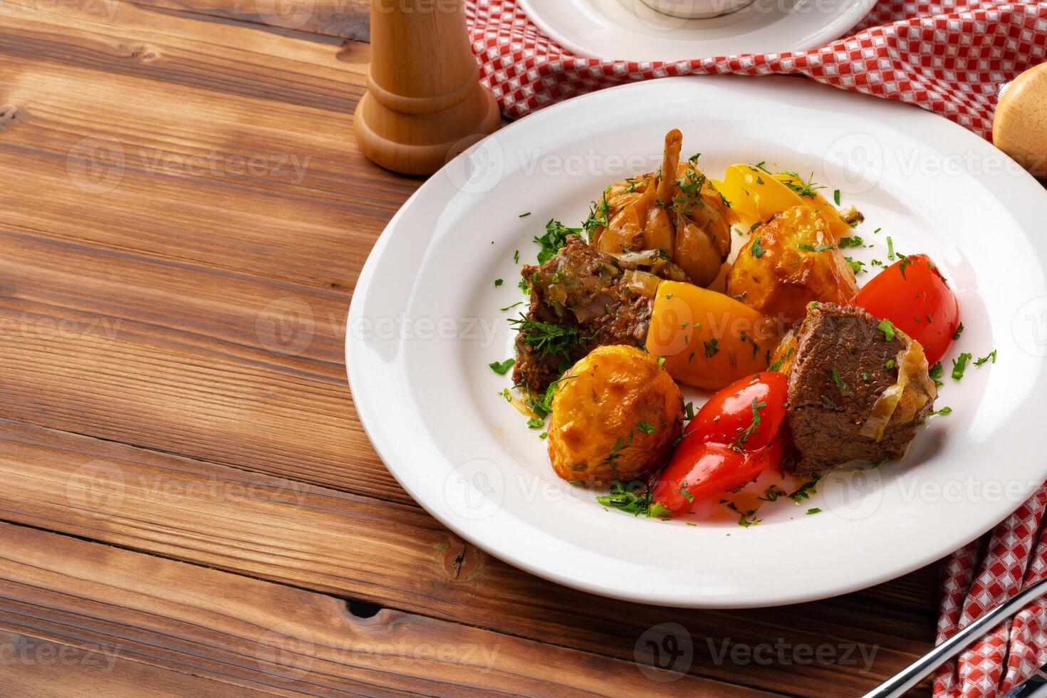 Beef meat stewed with potatoes on white plate photo