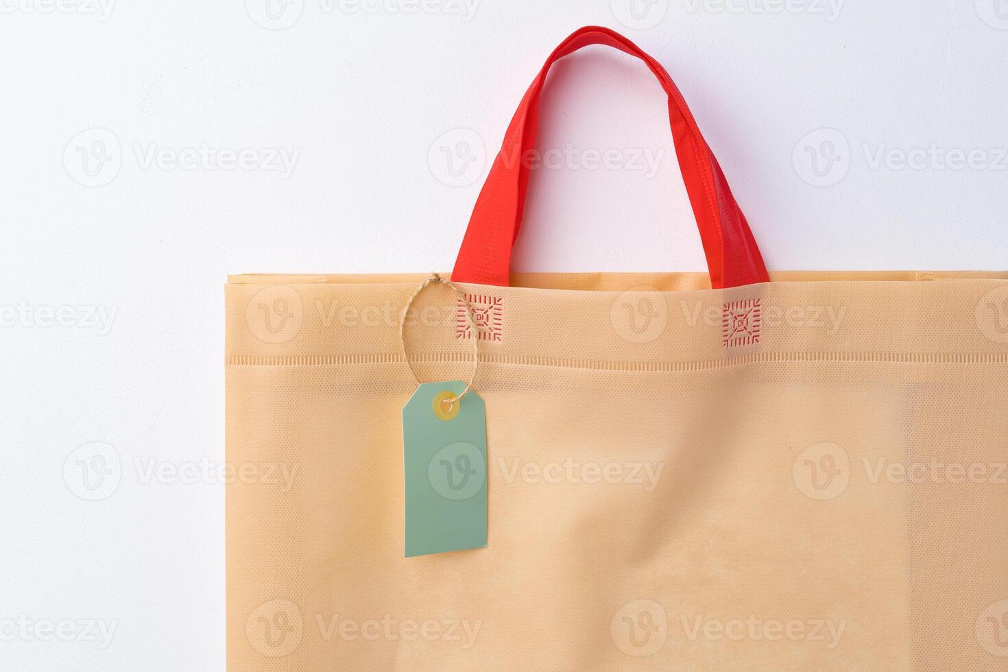 Blank paper tag with shopper paperbag on white background photo