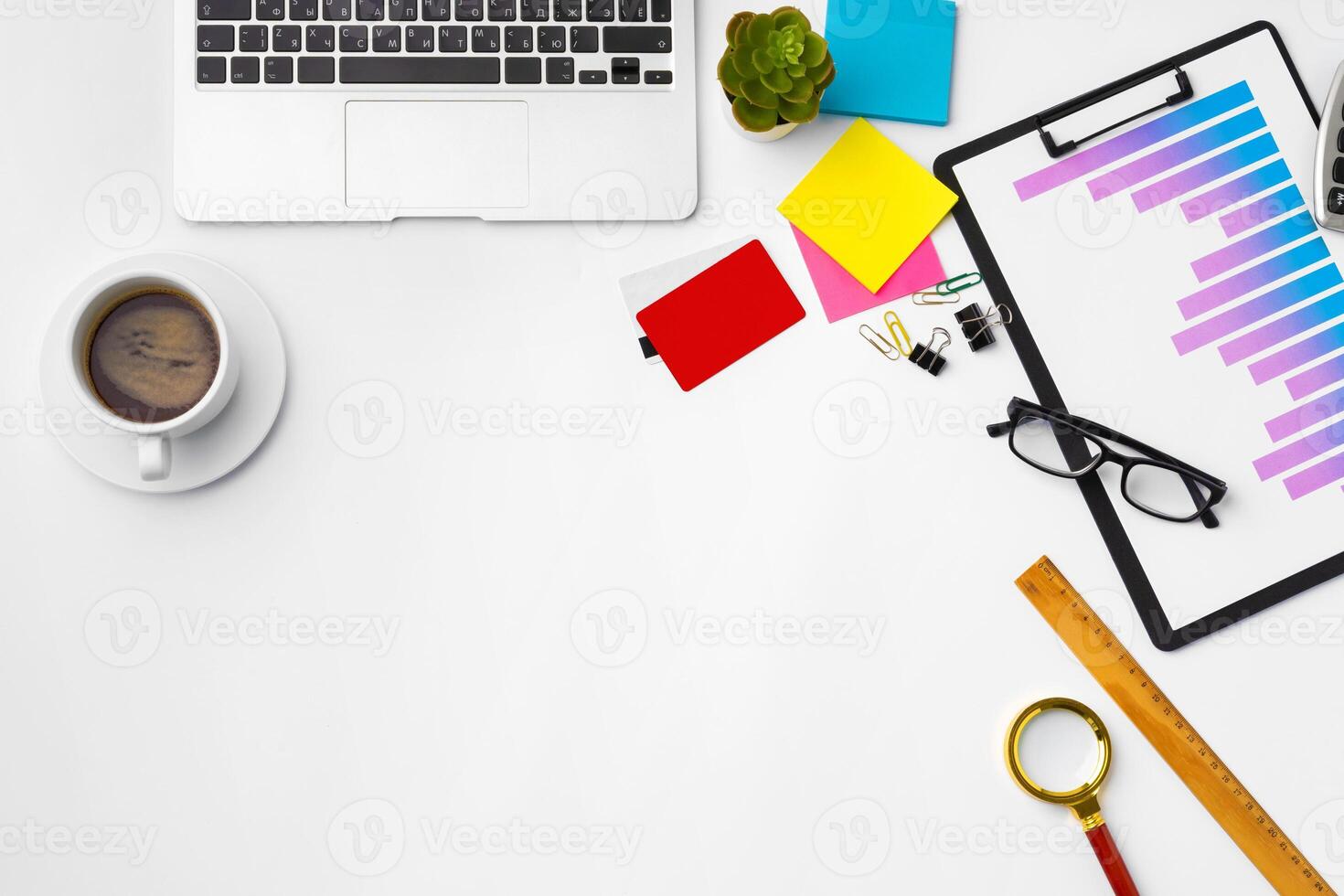 Office desk with laptop, blank notebook and coffee cup photo