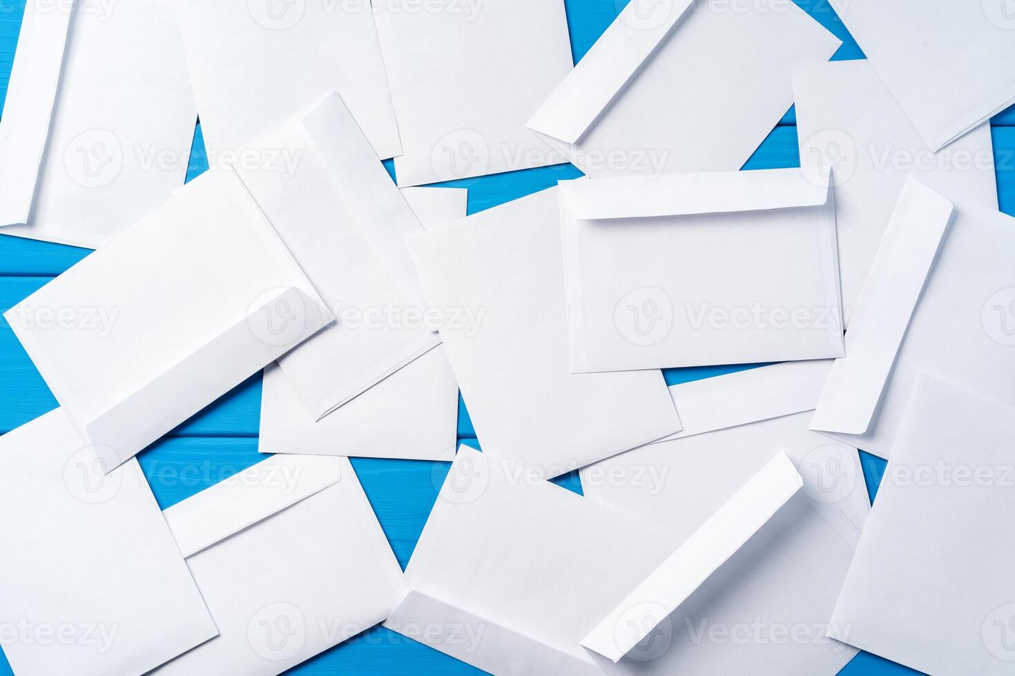Stack of envelopes on working desk top view. Business mail photo